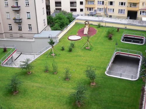 Vegetated underground garage with lawn, small trees and playground